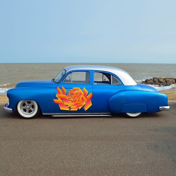 Customized blue vintage car on seafront promenade, sea and beac