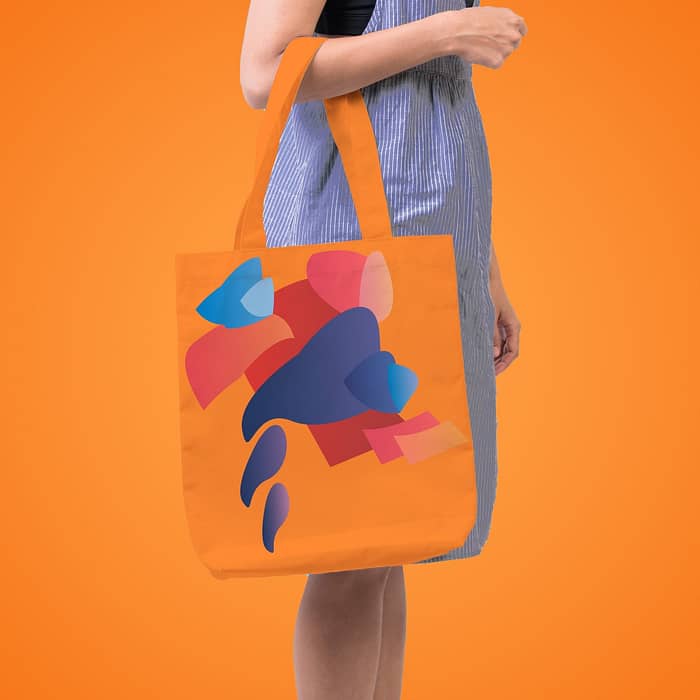 Girl is holding bag canvas fabric for mockup blank template isolated on blue background.